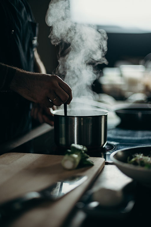 a person cooking vegetables, reducing their antinutrient content